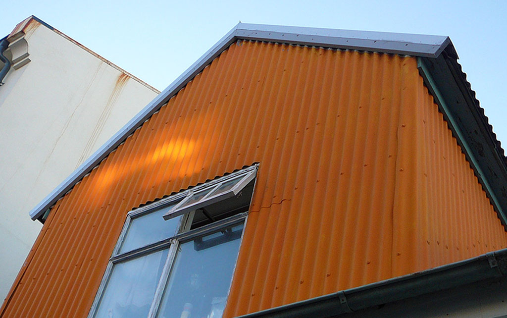 Orange painted corugated iron building in Iceland