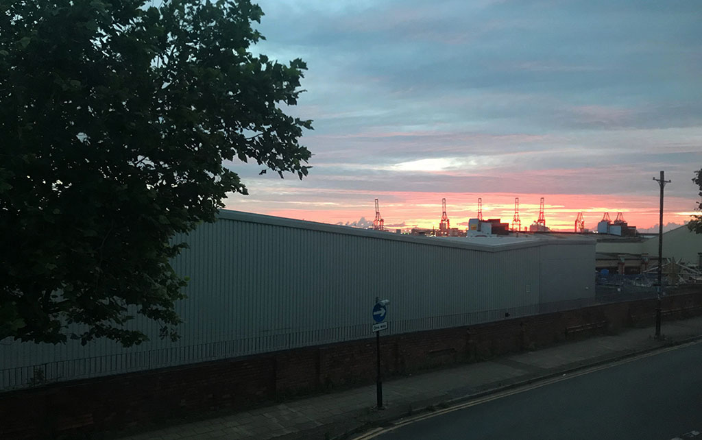 Liverpool's red shipping cranes at sunrise