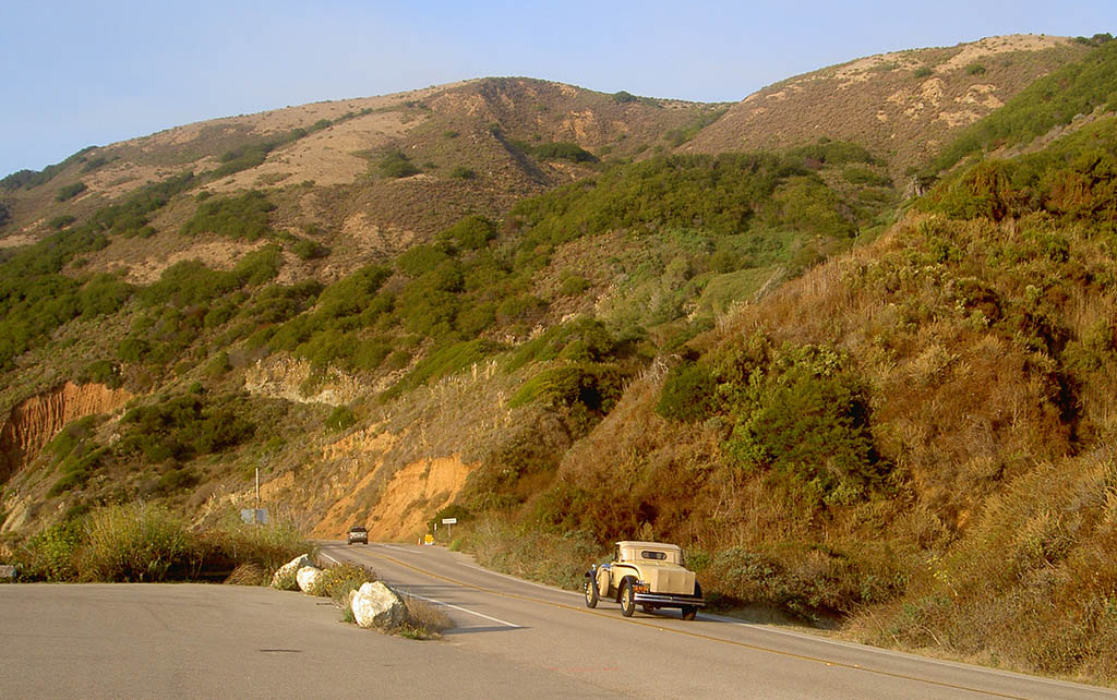 Old fashioned car driving up Big Sur
